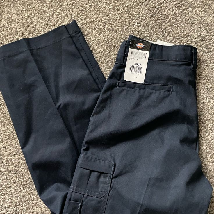 65% Polyester, 35% Cotton Twill Metal Buttons, Doubled Front Pocket Fabric, Reinforced Belt Loops & Crotch Ez-Touch Softened Fabric Relaxed Fit Stain-Release Cargo Pockets Accessed Via Concealed Zipper Closures Multi-Use Pocket Inside Left Cargo And Outside Right Cargo Navy Straight Leg Cargo Pants, Relaxed Fit Blue Cargo Pants With Belt Loops, Casual Navy Tapered Leg Work Pants, Navy Straight Leg Pants With Pockets, Blue Mid-rise Cargo Pants With Hip Pockets, Fitted Mid-rise Work Pants With Pockets, Casual Navy Bottoms With Belt Loops, Navy Utility Straight Leg Bottoms, Navy Straight Leg Utility Bottoms