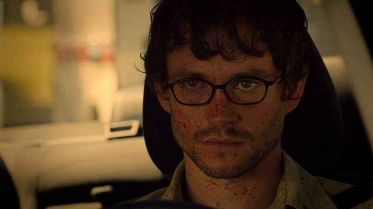 a man with freckles on his face sitting in a car