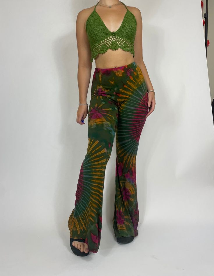 Long Tie Dye Flare Pants in green. Model is 5'2 for reference! Very stretchy, waist can stretch from 22' to 32' comfortably! Coloring and pattern will vary slightly in each pair! Casual Green Mid-rise Pants, Fitted Flare Bottoms In Green, Green Fitted Flare Bottoms, Fitted Flare Green Bottoms, Green Stretch Wide Leg Pants, Green Stretch Leggings With Elastic Waistband, Stretch Green Leggings With Elastic Waistband, Green Fitted High Waist Bottoms, Hippie High-waisted Fitted Pants