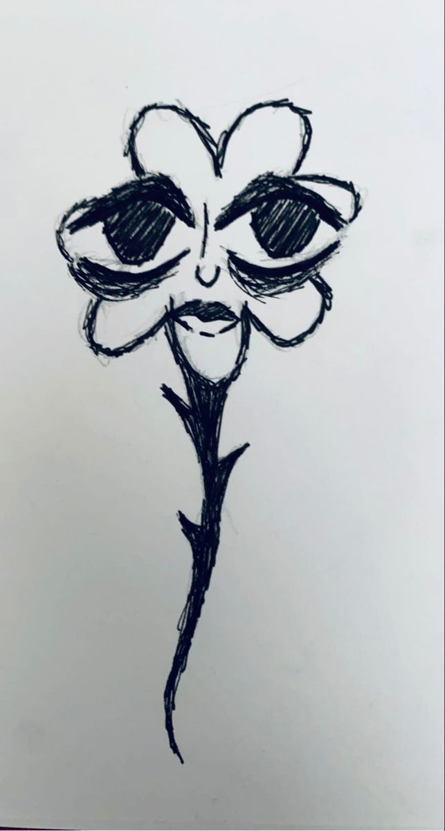 a black and white drawing of a flower with eyes drawn on it's side