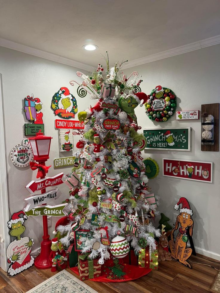 a white christmas tree decorated with candy canes and other holiday decorations in a room