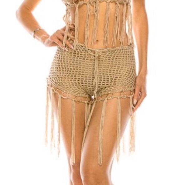 Our Desert Heights Beige Crochet Shorts Are Hot And High On Our List Of Favorite Festival Attire. These Shorts Feature Fringe On The Bottom With Silver Rings And An Adjustable Tie Waist. Pair Over Top Of Your Favorite Two Piece Set Or With One Of Our Vintage Scarves For A Show Stopping Look! Beige Color Fringe Bottom Silver Tone Rings Adjustable Tie Waist Tags: Coachella Stagecoach Crochet Lace Festival Burning Man Snowglobe Rave Summer Corduroy Distressed Rock N Roll Trendy Bohemian Boho Girly Fitted Beach Shorts For Summer, Beachy Shorts For Beach Season Festivals, Beachy Shorts For Festival And Beach Season, Bohemian Short Length Swimwear For Beach Season, Summer Festival Swimwear, Beach Festival Beachy Shorts, Beach Season Festival Beachy Shorts, Bohemian Short Swimwear For Beach Season, Fitted Shorts For Beach Vacation