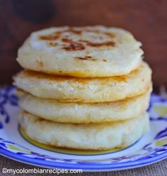 a stack of pancakes sitting on top of a blue and white plate