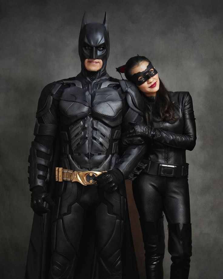 two people dressed up as batman and catwoman posing for a photo in their costumes