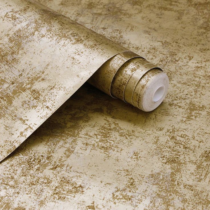 a roll of metallic tape sitting on top of a table next to a roll of toilet paper