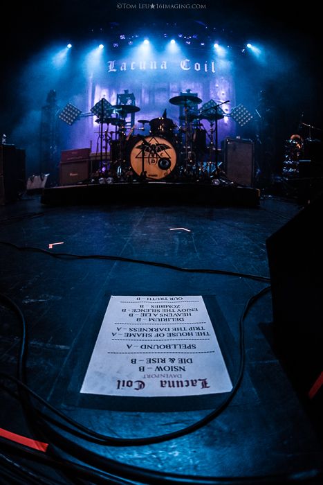 the stage is set up for a concert with blue lights and music equipment on it