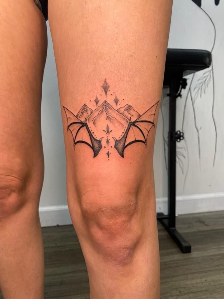 a woman's leg with a tattoo on it