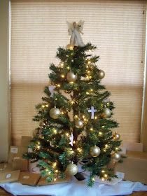 a small christmas tree with presents under it