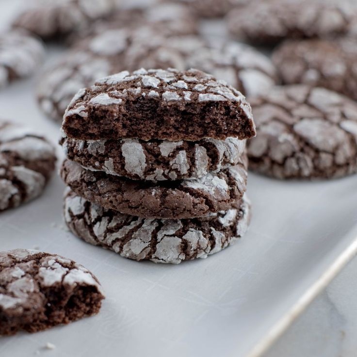 chocolate crinkle cookies are stacked on top of each other