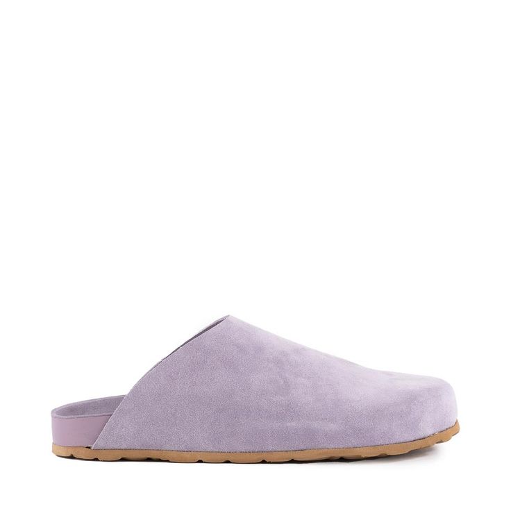 These Italian-made luxe leather slippers feature a molded footbed and closed toe design for maximum comfort. Available in Black Tumbled Leather, Lavender Suede, Taupe Suede, and Taupe V-Shearling. Heel Height: 1.25” Platform: 1.25” Material: Black, Lavender, and Taupe are Leather Taupe V-Shearling is Synthetic Fit: Tru Slip-on Mules With Textured Footbed And Round Toe, Slip-on Flat Clogs With Textured Footbed, Comfortable Closed Toe Leather Mules, Leather Slip-on Clogs With Textured Footbed, Slip-on Clogs With Textured Footbed And Flat Heel, Leather Slip-on Mules With Textured Footbed, Leather Mules With Textured Footbed, Comfortable Mules With Leather Footbed And Flat Heel, Leather Closed Toe Mules With Textured Footbed