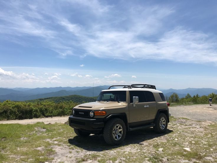 an suv parked on top of a hill