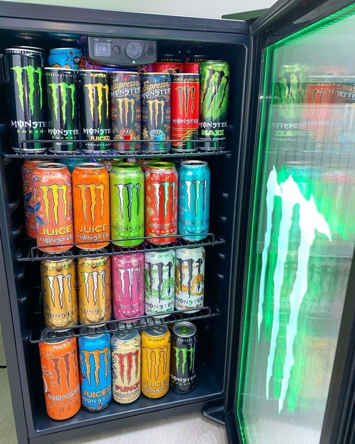 an open refrigerator filled with lots of different types of sodas and cans in it