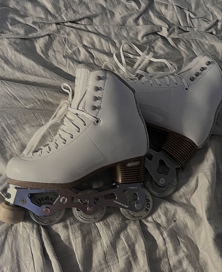 a pair of ice skates sitting on top of a bed