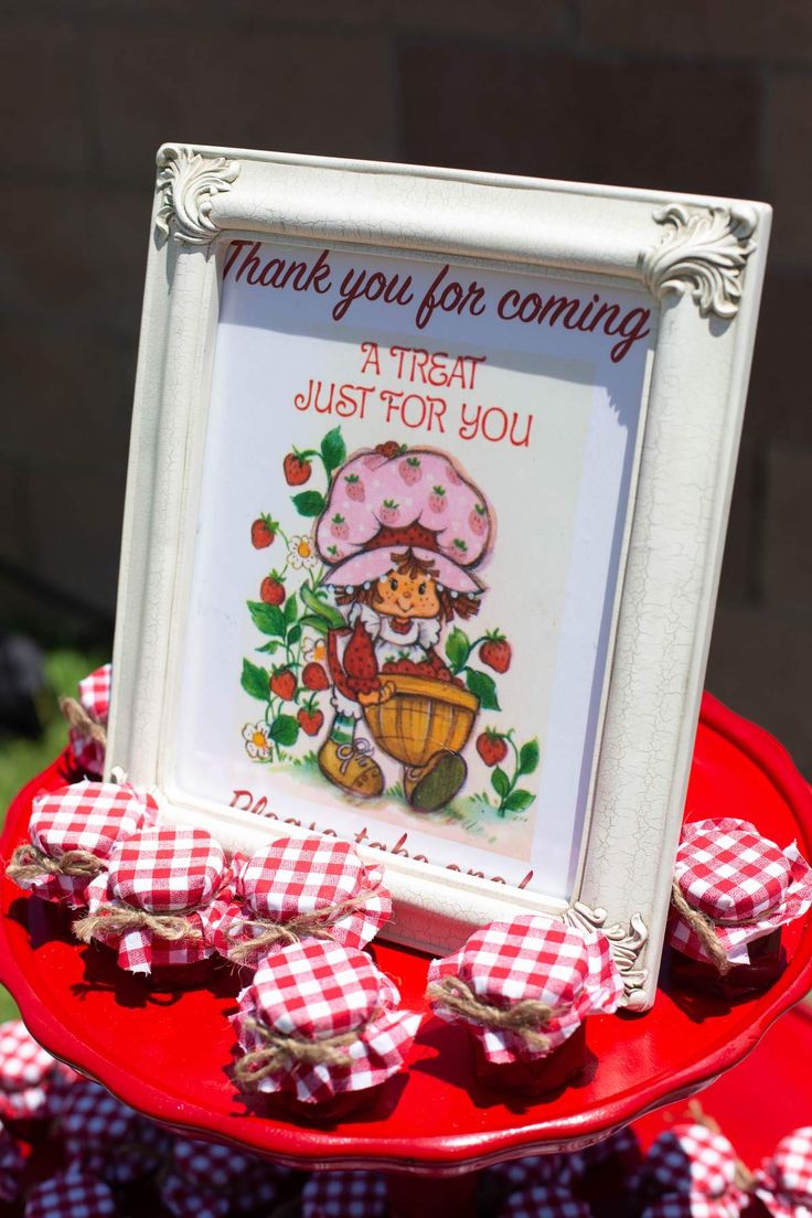 a red and white plate topped with cupcakes next to a sign that says thank you for coming