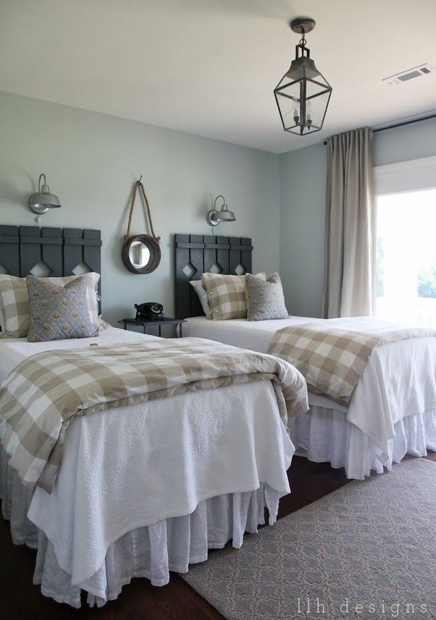 two beds in a bedroom with white and tan bedding