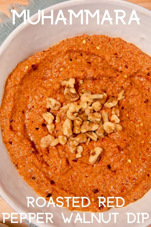 a white bowl filled with red pepper walnut dip