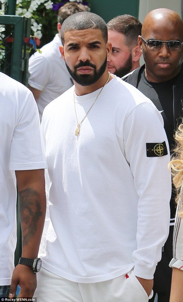 a man in white shirt and shorts standing next to other people