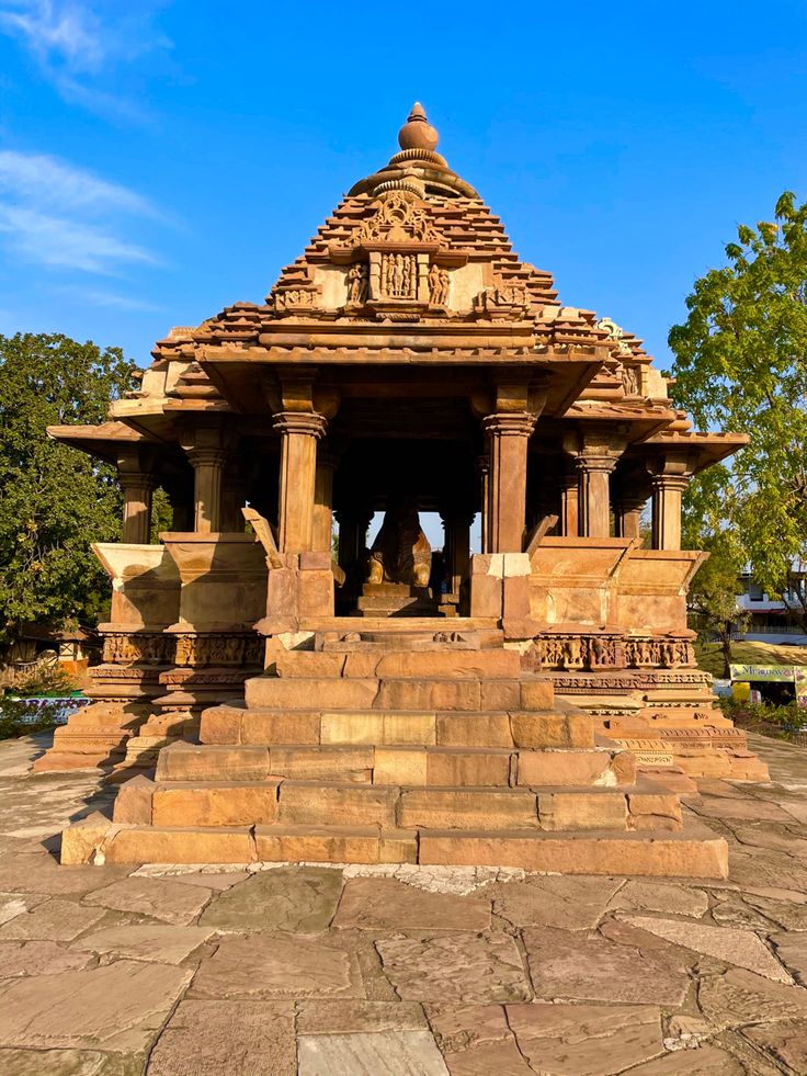 a small stone structure with statues on it