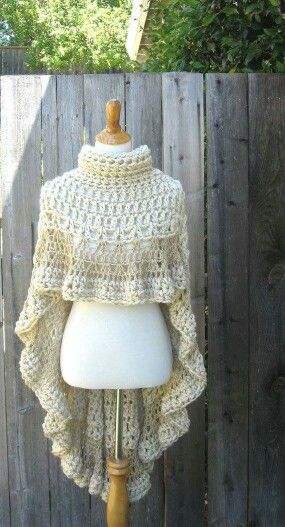 a white mannequin with a crochet cape on it's head