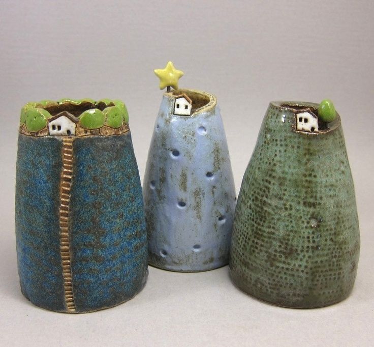 three ceramic vases sitting next to each other