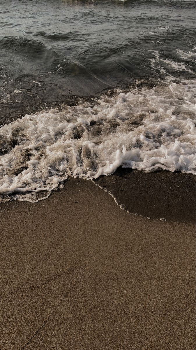 the waves are coming in to the beach and it looks like they're getting wet