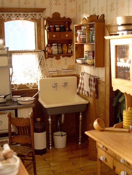 an old fashioned kitchen with wood floors and cabinets