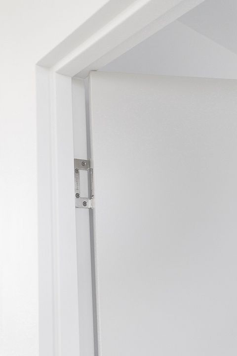 an open white door with a handle on it