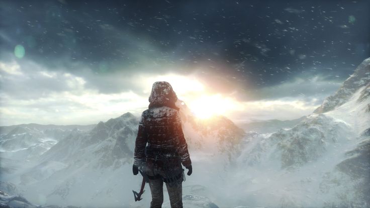 a man standing on top of a snow covered mountain