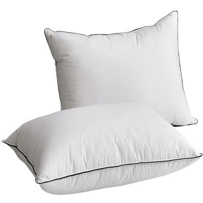 two white pillows sitting next to each other