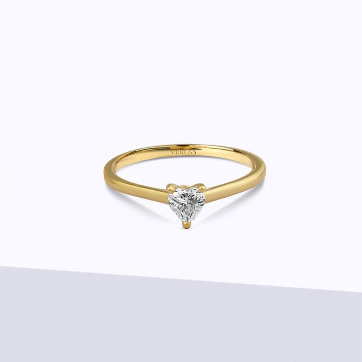 The Iconic Heart Ring is a romantic expression of love. The heart-shaped diamond, beautifully set in a gold/platinum band, captures the essence of passion and devotion. Crafted with precision and attention to detail, this ring is a heartfelt symbol of everlasting love that will make your heart skip a beat. Heart Ring With Single Diamond In Round Cut, Heart Shaped Diamond Ring With Single Diamond, 14k Gold Heart-shaped Solitaire Ring, Classic 14k Gold Heart Ring With Single Diamond, Fine Jewelry Heart Ring With Single Round Cut Diamond, Heart-shaped Single Diamond Fine Jewelry Ring, Heart-shaped Diamond Ring With Single Diamond, Heart-shaped Diamond Ring With Single Stone, Formal Heart-shaped Diamond Ring With Single Diamond