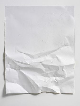 a piece of white paper that has been torn in half