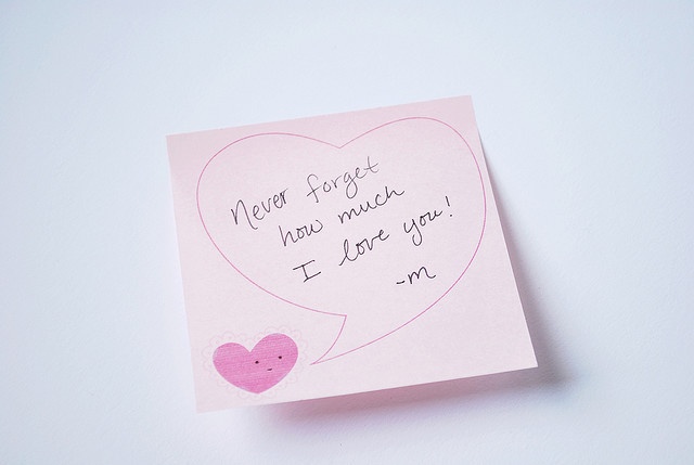 a pink note with a heart on it that says never forget how much i love you