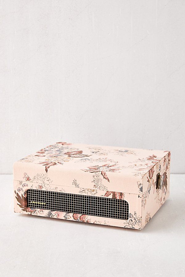 a pink floral box sitting on top of a white table