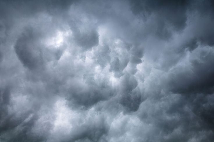 an airplane is flying in the cloudy sky