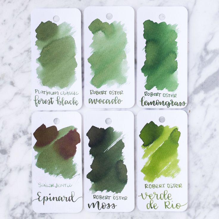 four different shades of green and brown ink on a marble surface with the names of each color