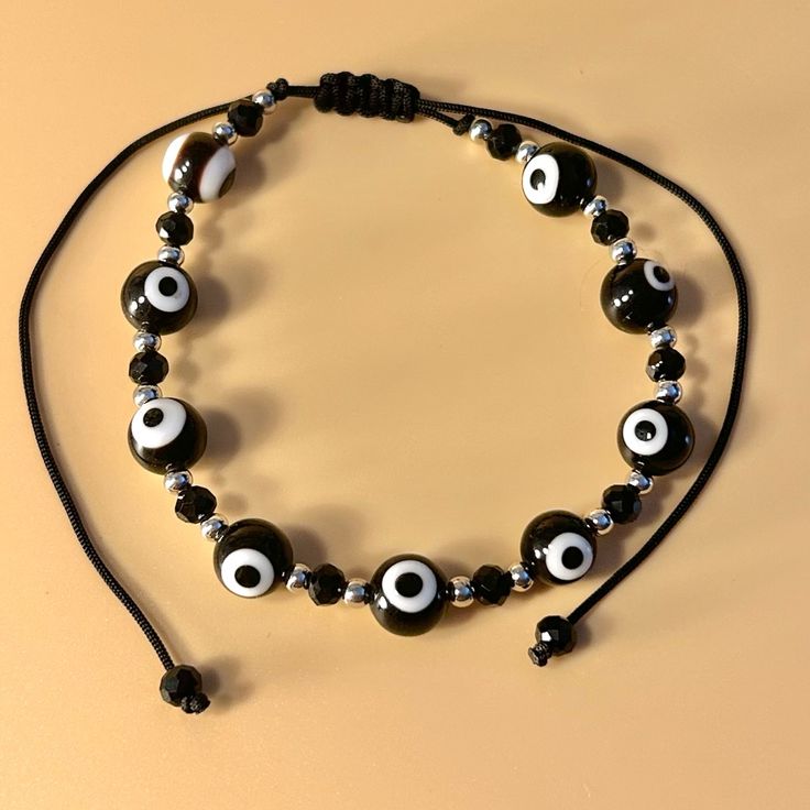 a black and white beaded bracelet with evil eyes