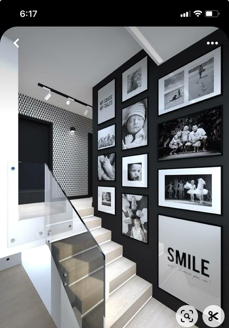 a staircase with pictures on the wall next to it