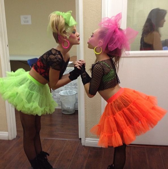 two women dressed up in neon colored costumes