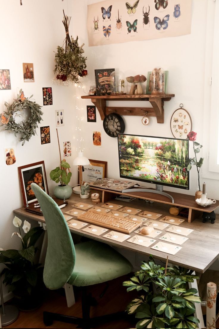 a home office with lots of plants and pictures on the wall