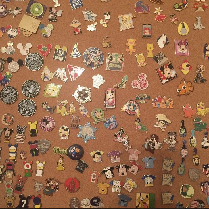 a wall covered in lots of different types of pins and magnets on top of it