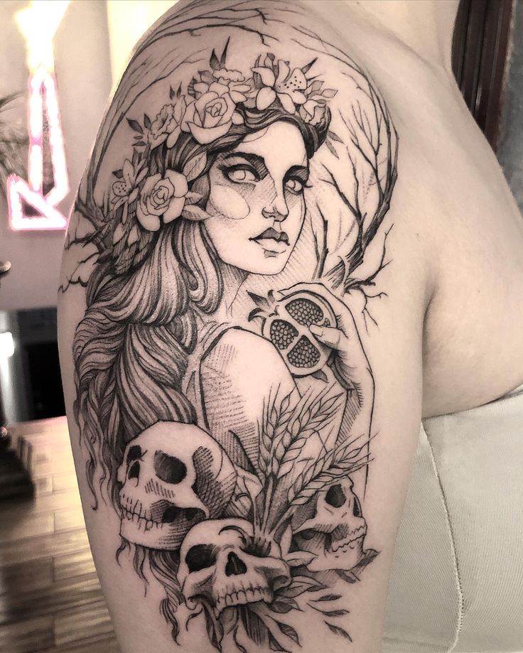 a woman with flowers and skulls tattoo on her arm is shown in black and white