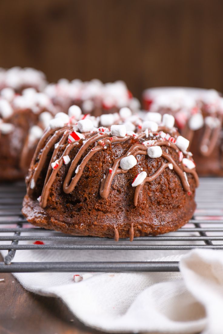 chocolate peppermint bundt cakes on a cooling rack with white and red sprinkles