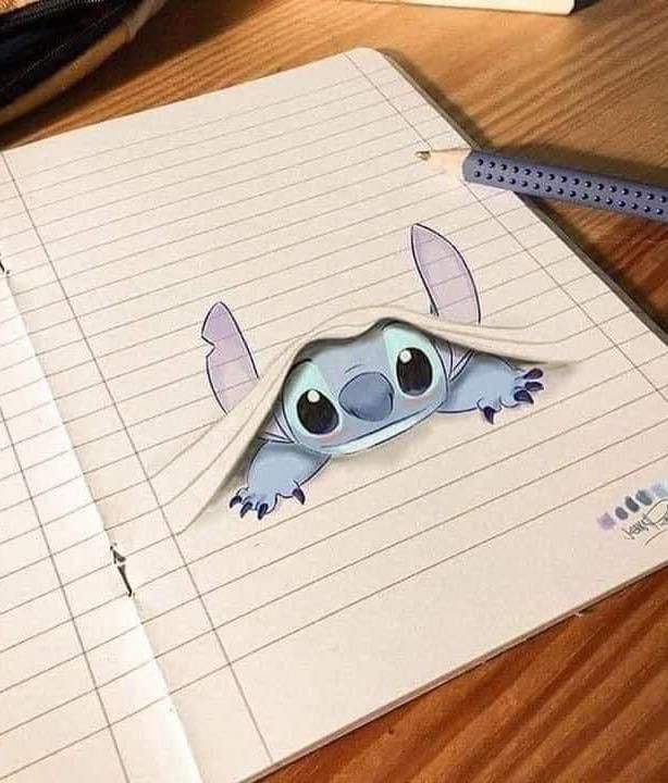 a notebook with an image of a koala peeking out of it's hole