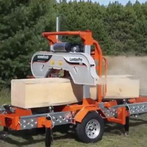 an orange tractor trailer driving through a field