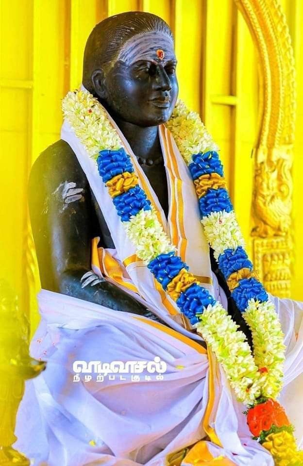 the statue is decorated with flowers and garlands