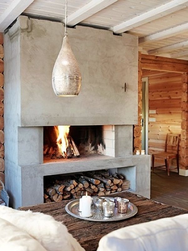 a living room filled with furniture and a fire place next to a wall covered in logs