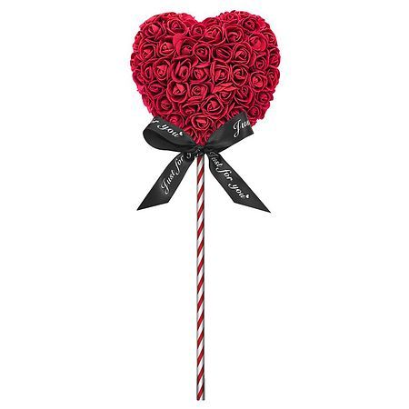 a heart shaped lollipop with roses and a black ribbon on it's end