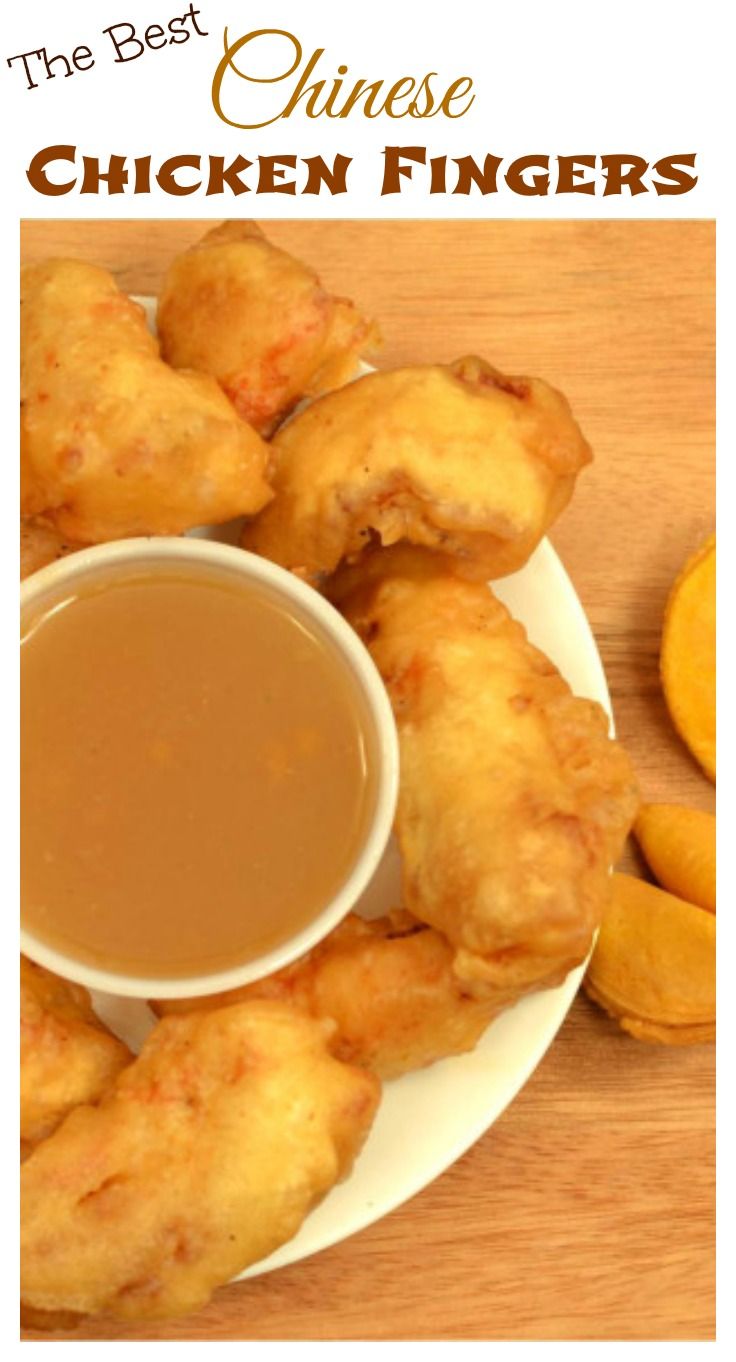 the best chinese chicken fingers with dipping sauce on a white plate next to sliced oranges