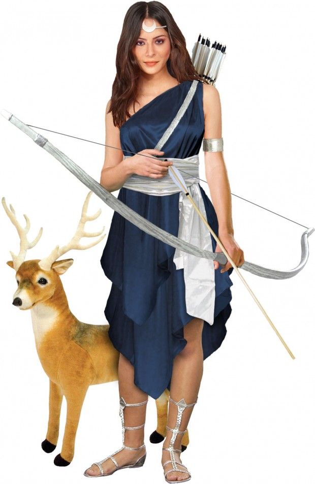 a woman dressed in greek clothing holding an arrow and bow with a deer standing next to her