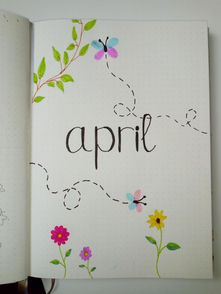 an open notebook with the word april written in black ink and painted flowers on it